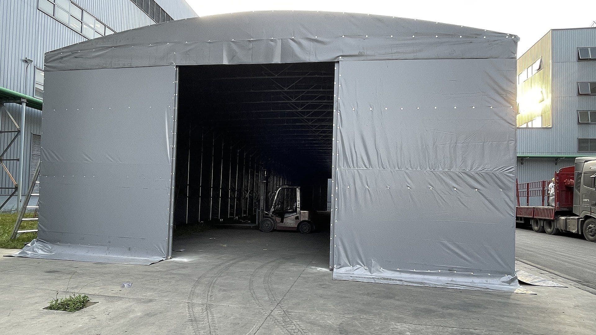 Grey mobile storage shelter — front opening view